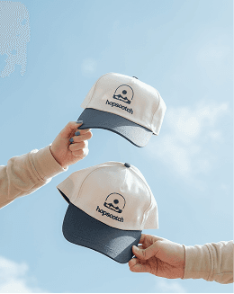 Merch Caps held to the sky